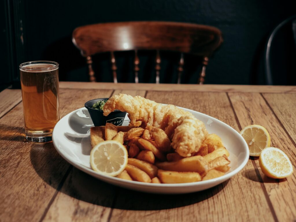 A plate of fish and chips on a wooden table