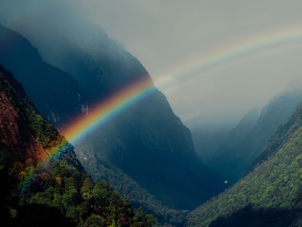 A rainbow spanning between mountains